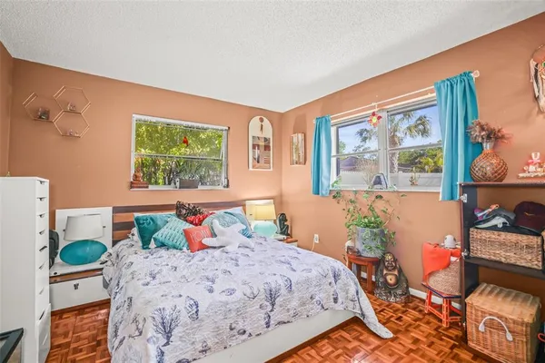 a bedroom with a bed and wooden floor