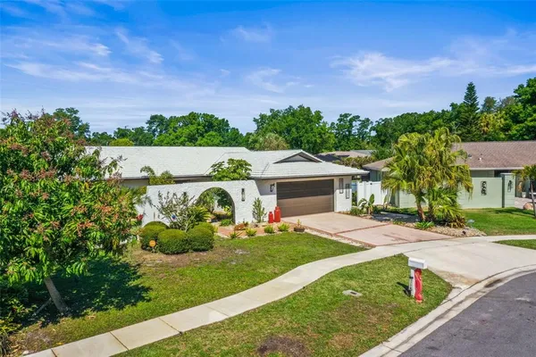 a front view of a house with a garden and yard