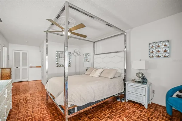 a bedroom with a bed and a chandelier