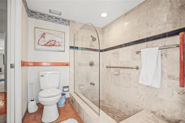 a bathroom with a toilet sink and shower