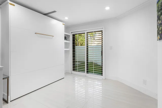 a bedroom with a bed couch and window