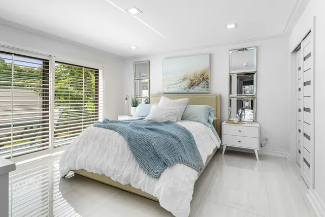 a spacious bathroom with a double vanity sink a mirror and a bathtub