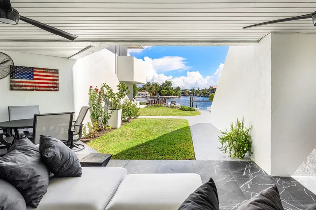 an aerial view of a house with swimming pool patio and outdoor seating