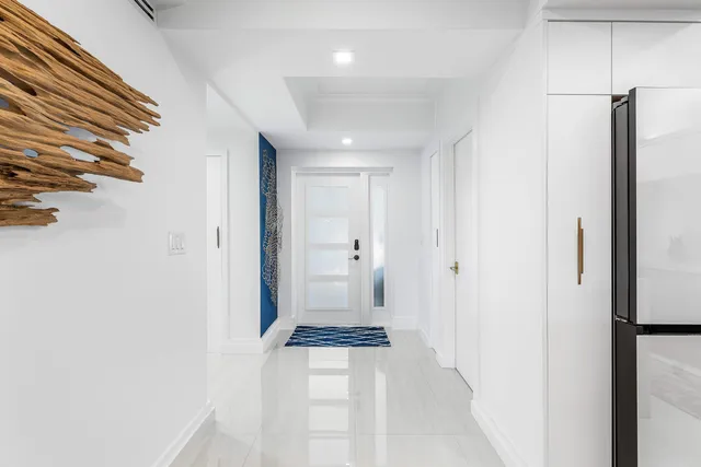 a kitchen with a sink dishwasher and a stove with a dining table