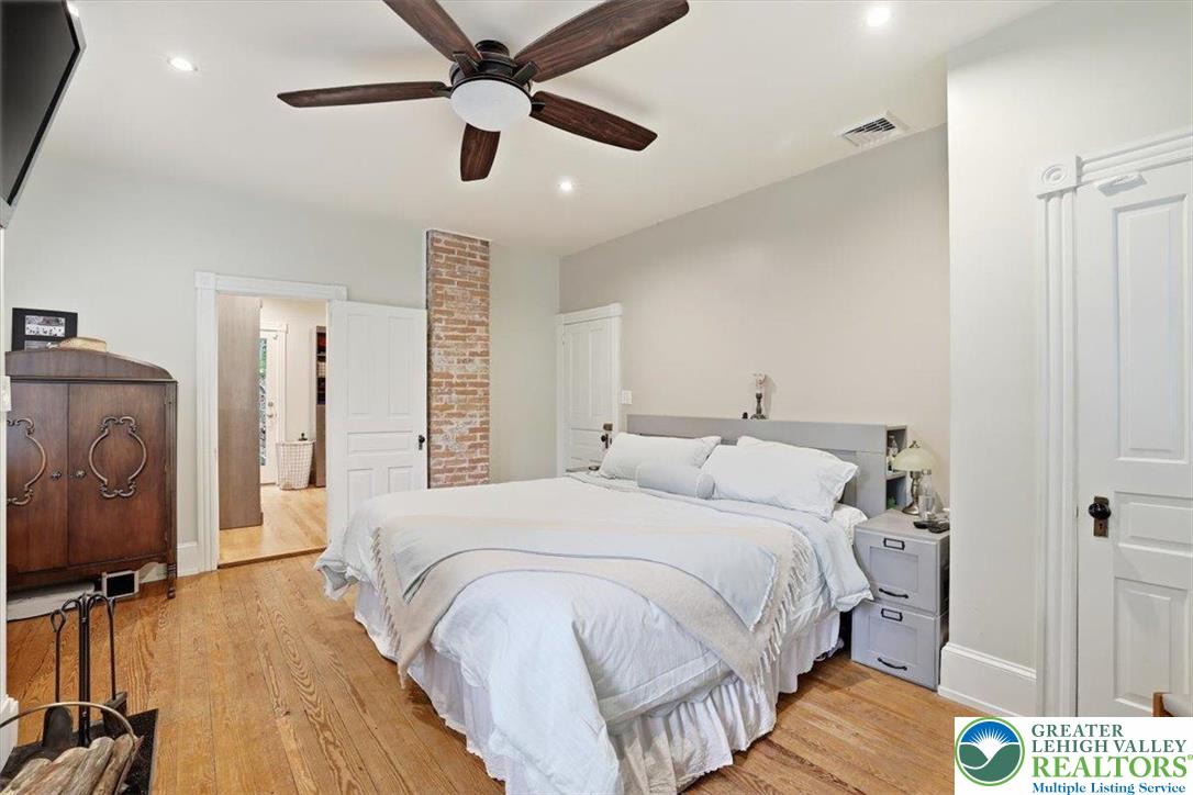 3585 Fairyland Road Lehighton, PA 18235 - Photo 41 of 57 a spacious bedroom with a bed and a chandelier
