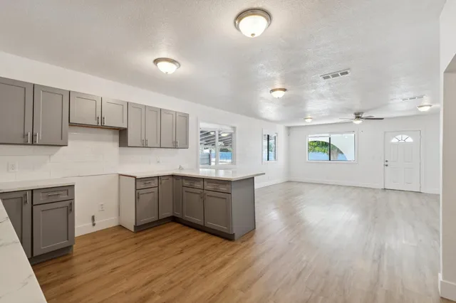 a kitchen with a sink cabinets and wooden floor