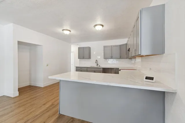 a kitchen with stainless steel appliances a sink a stove a refrigerator and cabinets