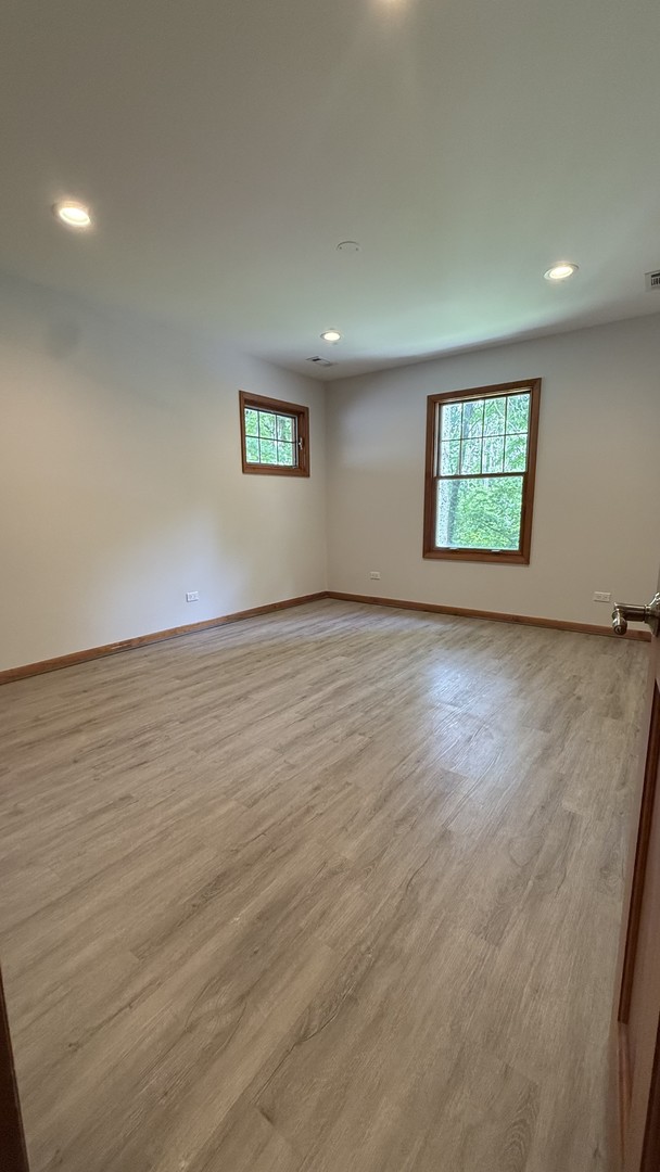 2841 Orange Brace Road Deerfield, IL 60015 - Photo 25 of 30 an empty room with wooden floor and windows