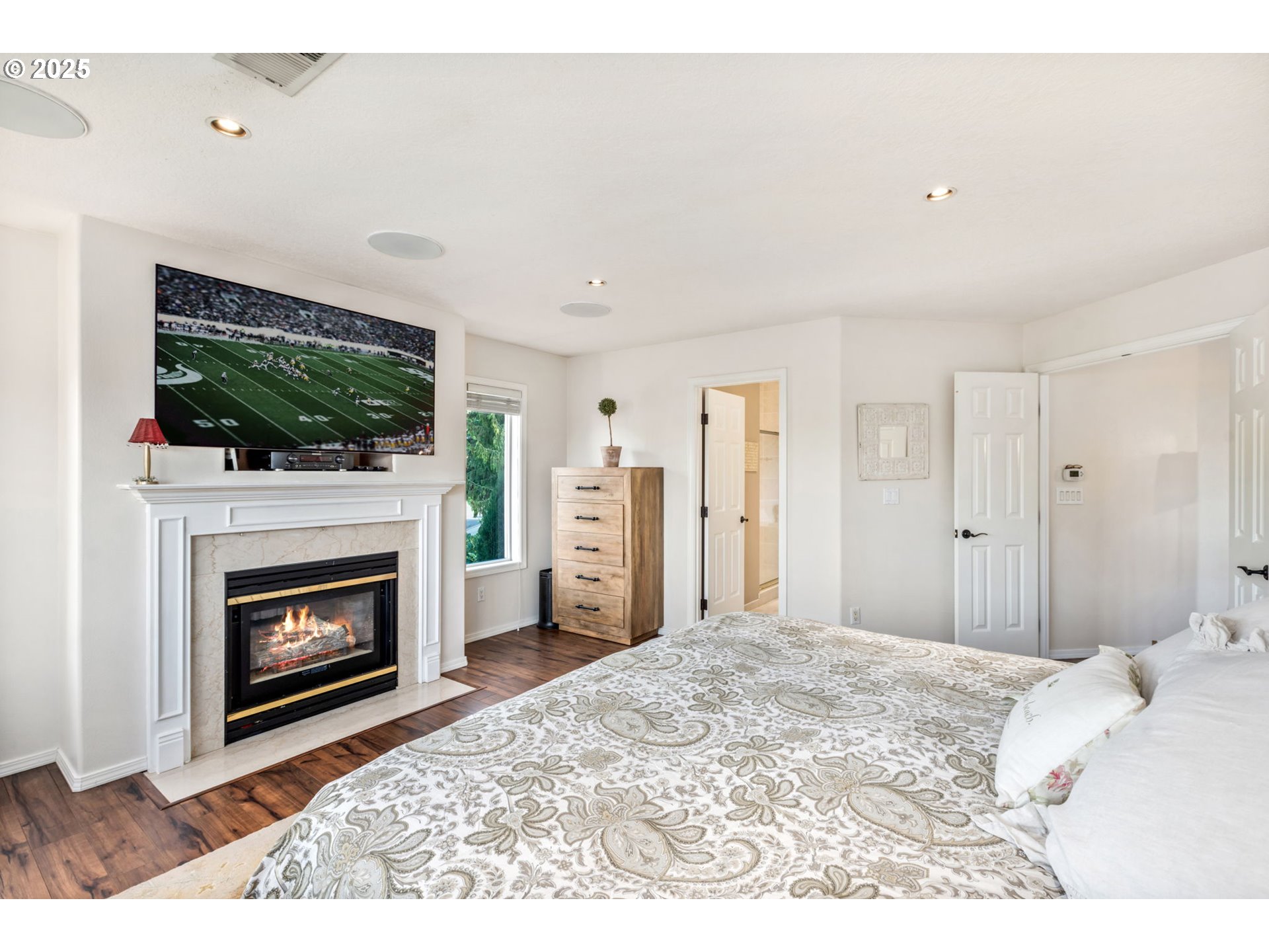 12176 Southwest Ames Lane Portland, OR 97224 - Photo 19 of 46 a bedroom with a bed and a fireplace