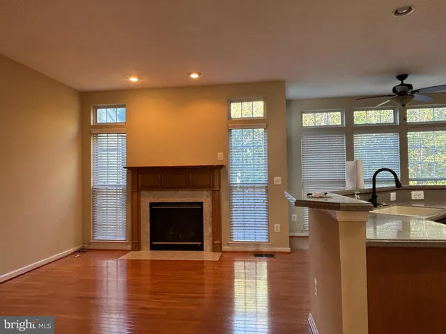 a kitchen with stainless steel appliances granite countertop a stove a sink and a large window