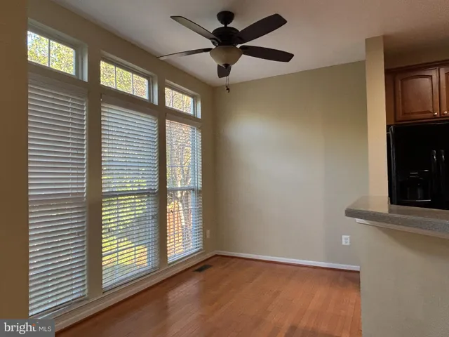 a view of room with a ceiling fan and a window