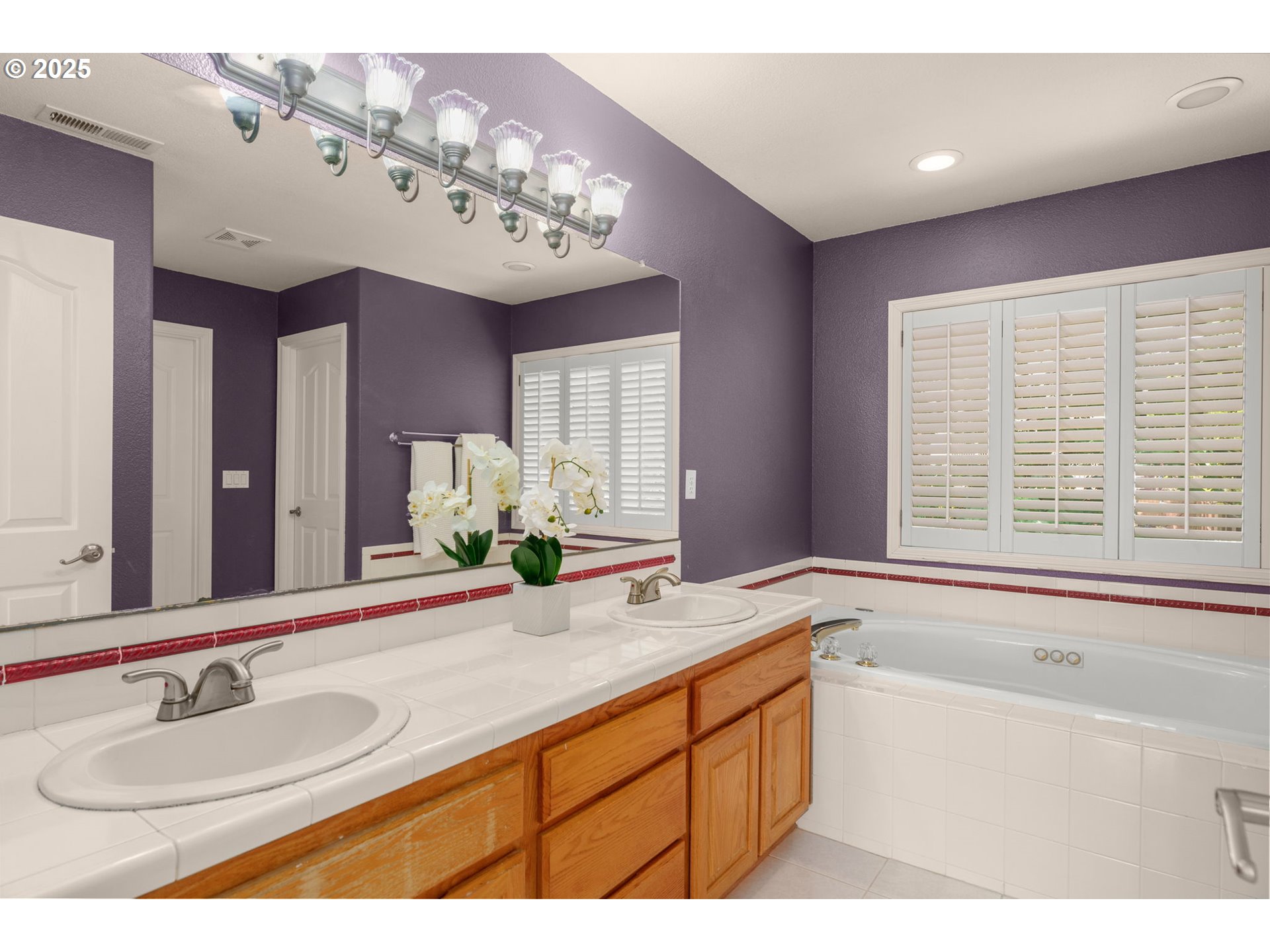1318 Northwest Slocum Way Portland, OR 97229 - Photo 20 of 33 a bathroom with a sink mirror and a bathtub next to a window