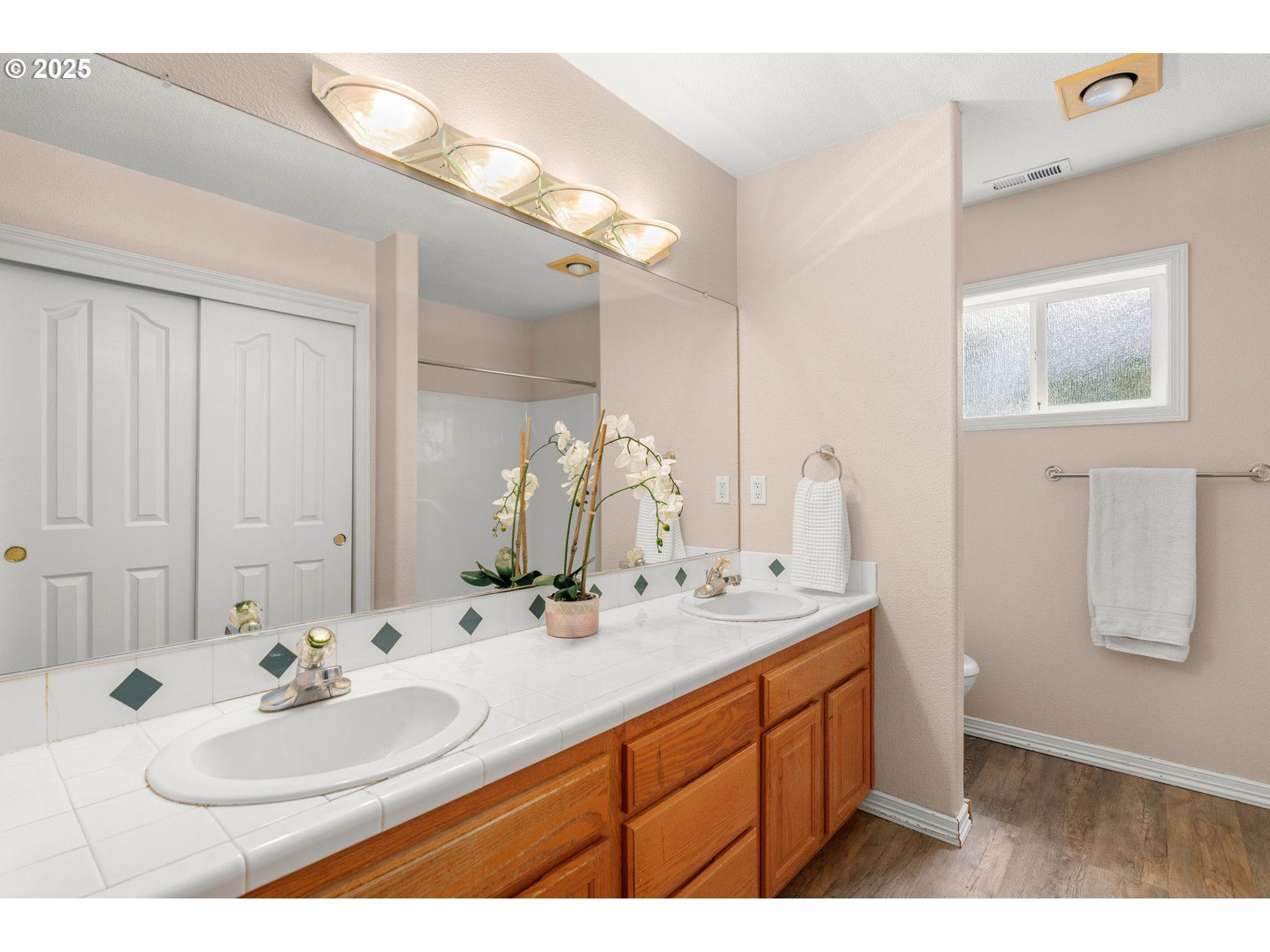 1318 Northwest Slocum Way Portland, OR 97229 - Photo 24 of 33 a bathroom with a sink and a mirror