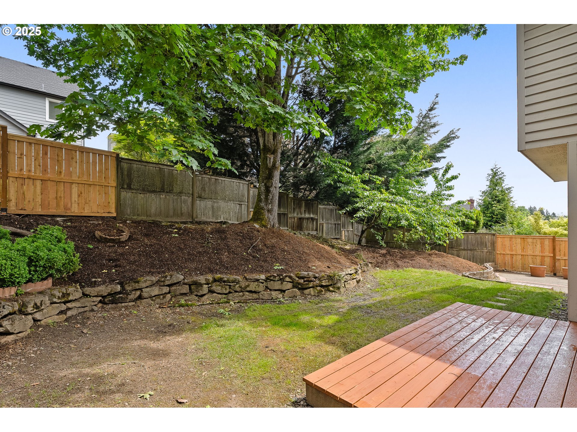 1318 Northwest Slocum Way Portland, OR 97229 - Photo 28 of 33 a view of a backyard with wooden fence