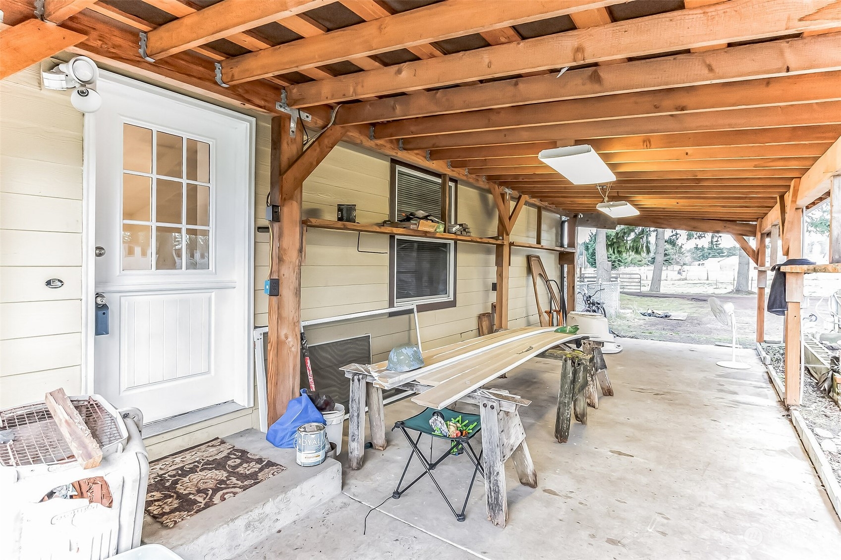 18222 Guava Street Southwest Rochester, WA 98579 - Photo 2 of 13 a view of a patio with table and chairs and wooden floor