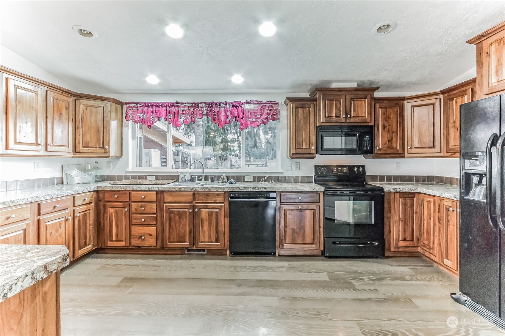 18222 Guava Street Southwest Rochester, WA 98579 - Photo 4 of 13 a kitchen with stainless steel appliances granite countertop a stove top oven a sink dishwasher and a microwave oven on the granite countertops