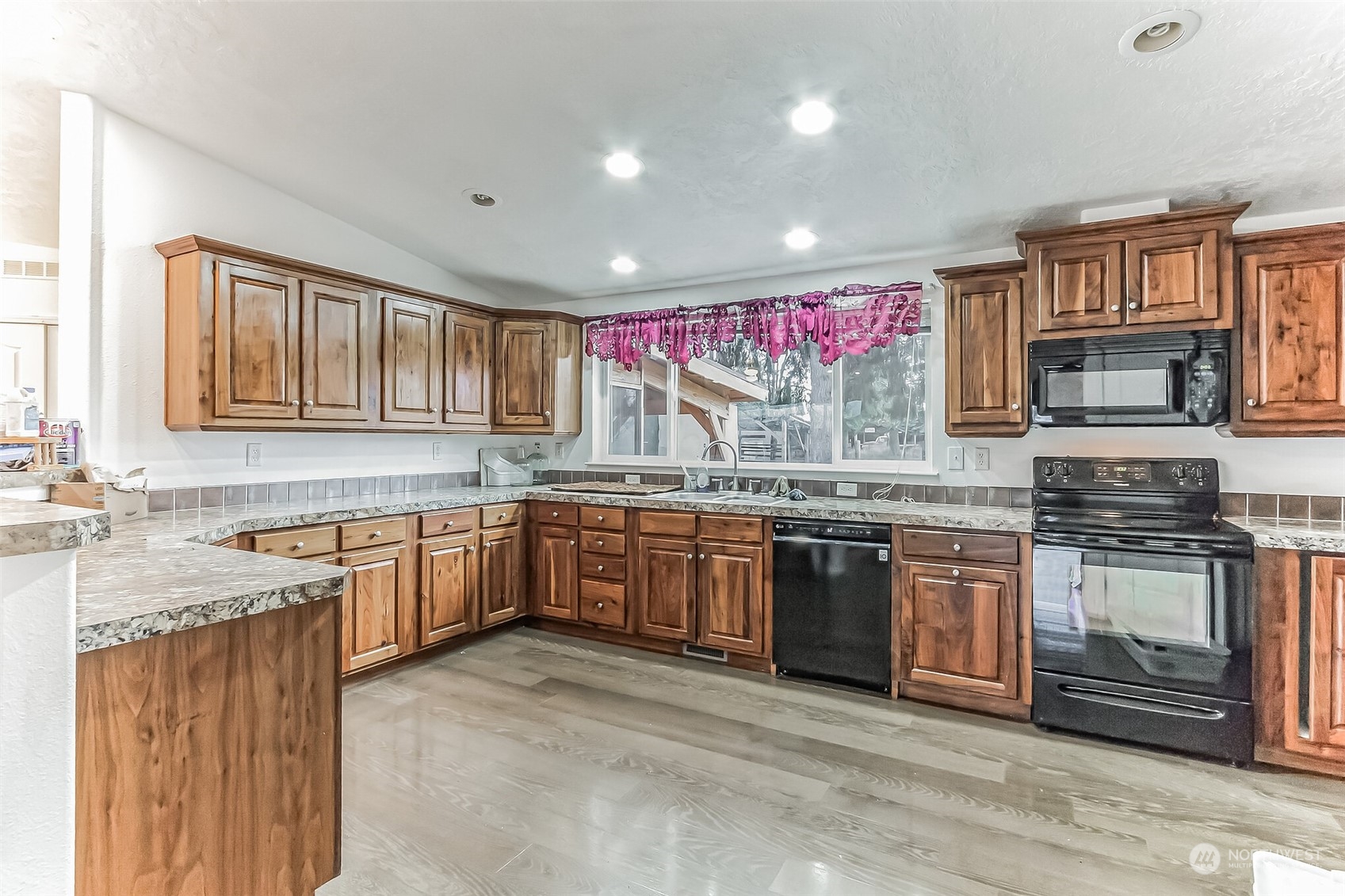 18222 Guava Street Southwest Rochester, WA 98579 - Photo 5 of 13 a kitchen with stainless steel appliances granite countertop a stove sink microwave and cabinets
