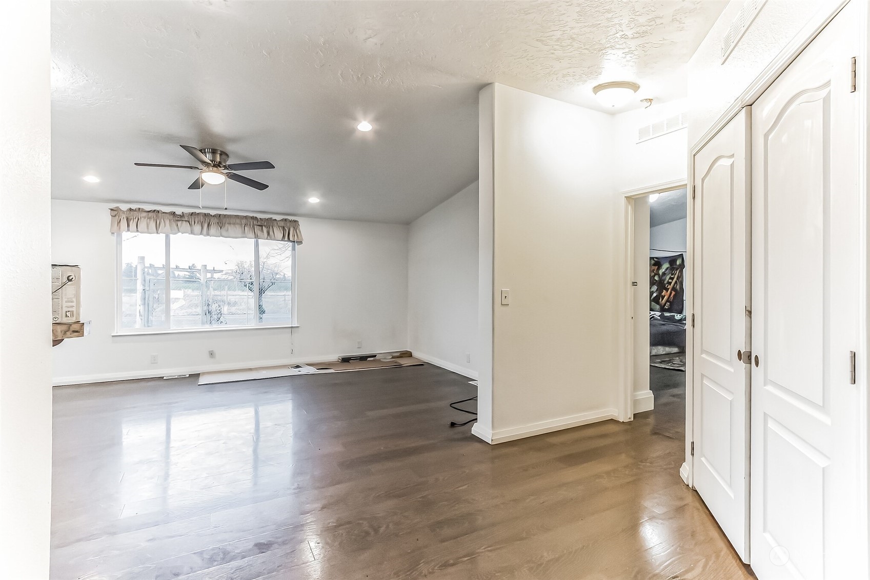 18222 Guava Street Southwest Rochester, WA 98579 - Photo 8 of 13 an empty room with wooden floor and windows