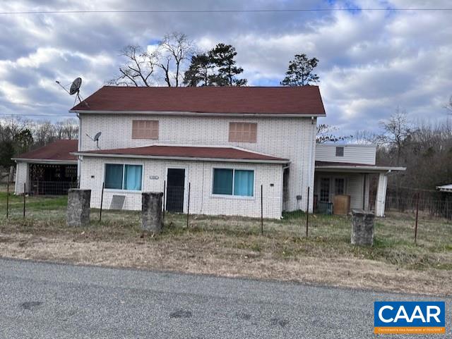 a view of a house with a yard and a garage