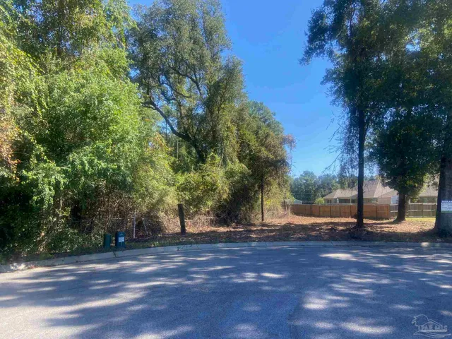 a view of dirt yard with a trees