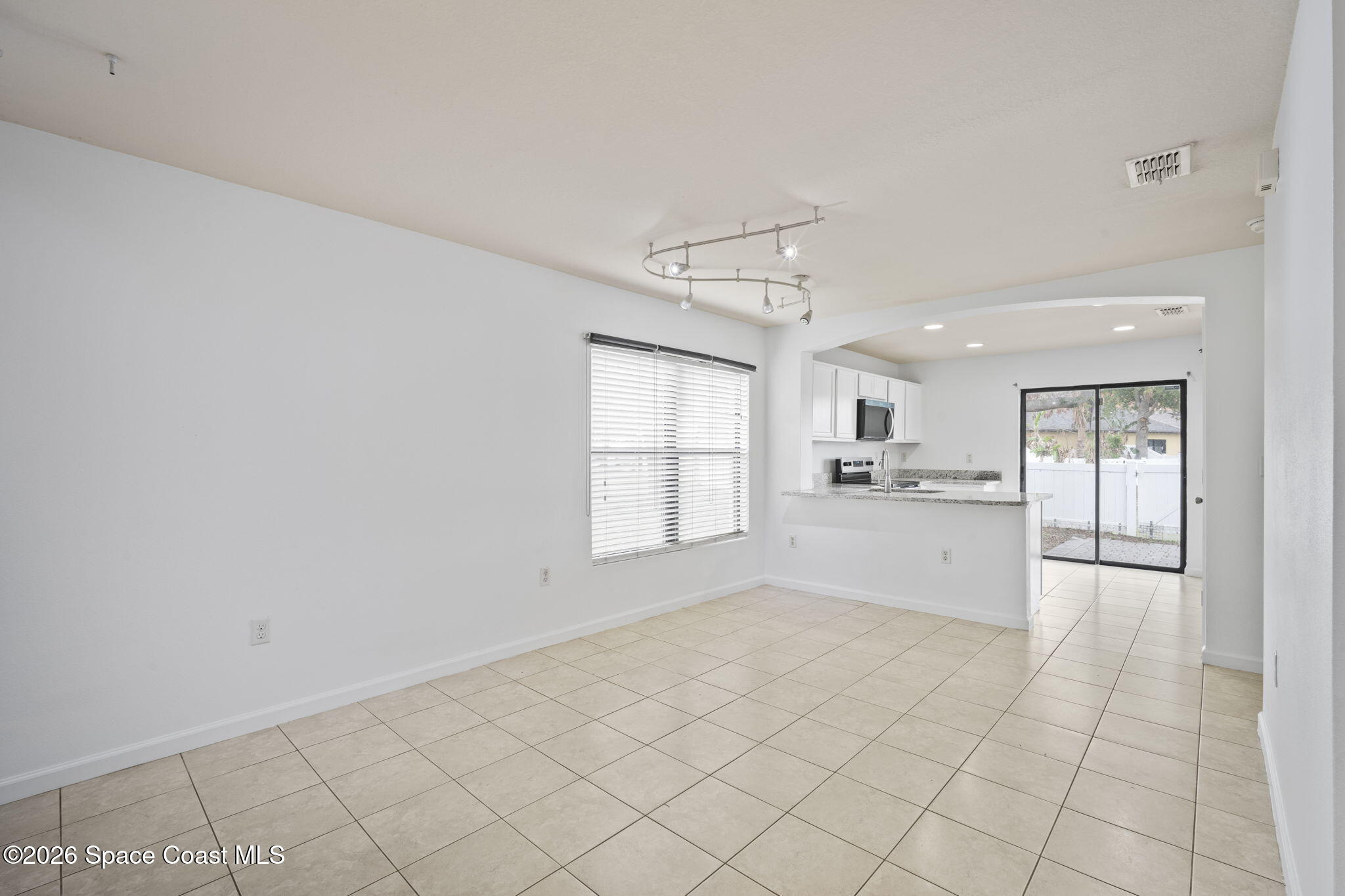 4555 Radiant Way, Unit 103 Melbourne, FL 32901 - Photo 13 of 58 a view of a kitchen with microwave and cabinets