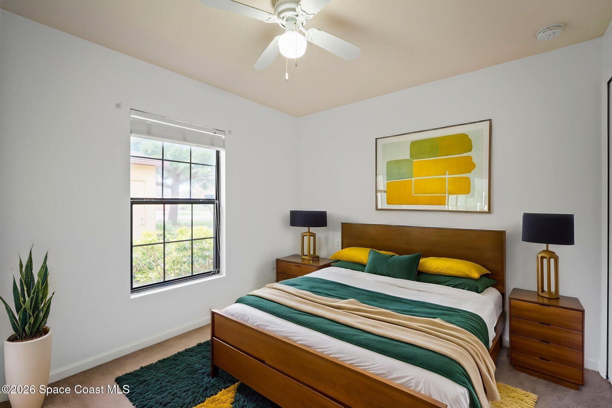 4555 Radiant Way, Unit 103 Melbourne, FL 32901 - Photo 24 of 58 a bedroom with a bed and a potted plant