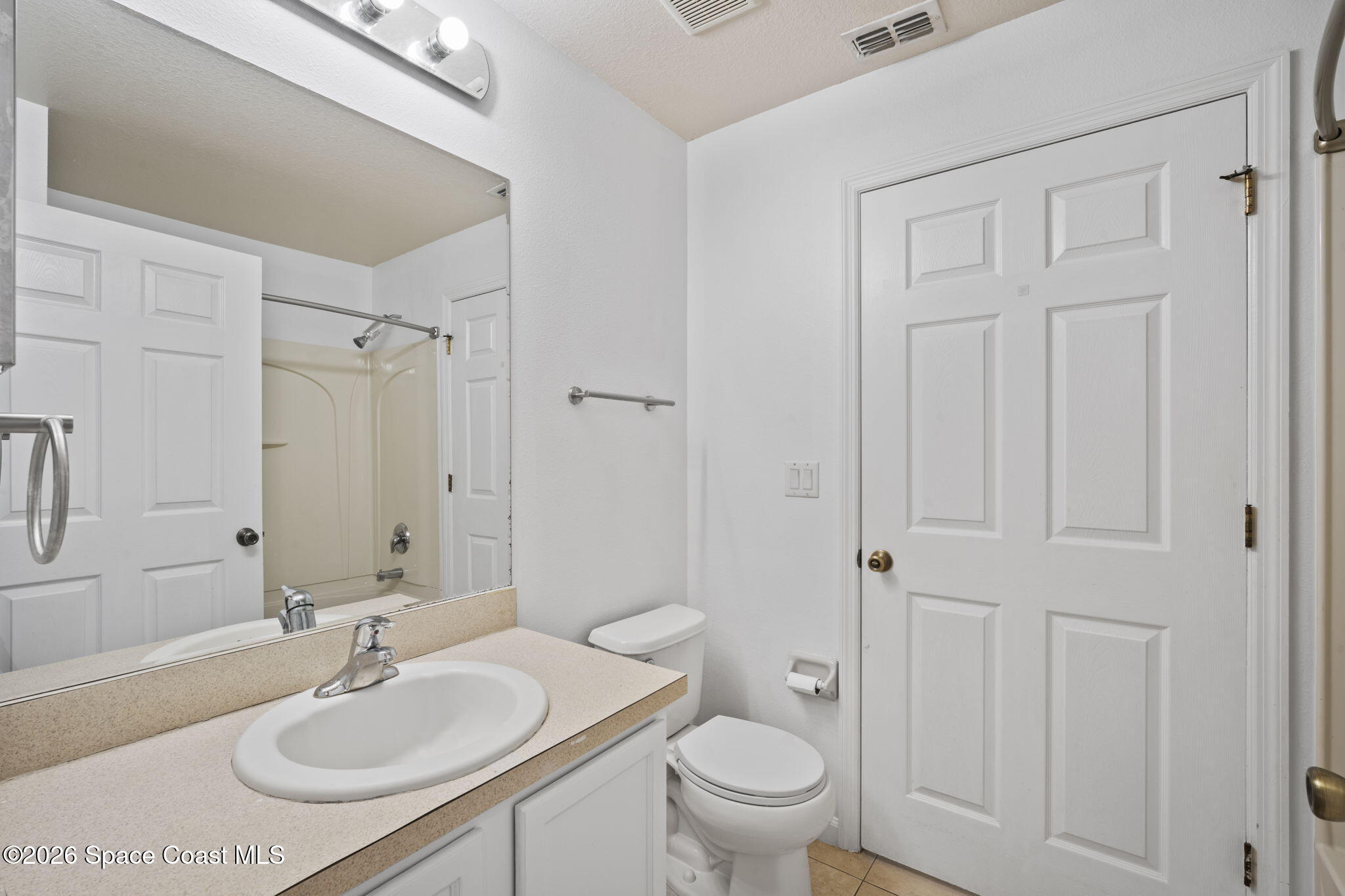 4555 Radiant Way, Unit 103 Melbourne, FL 32901 - Photo 26 of 58 a bathroom with a sink a toilet and shower
