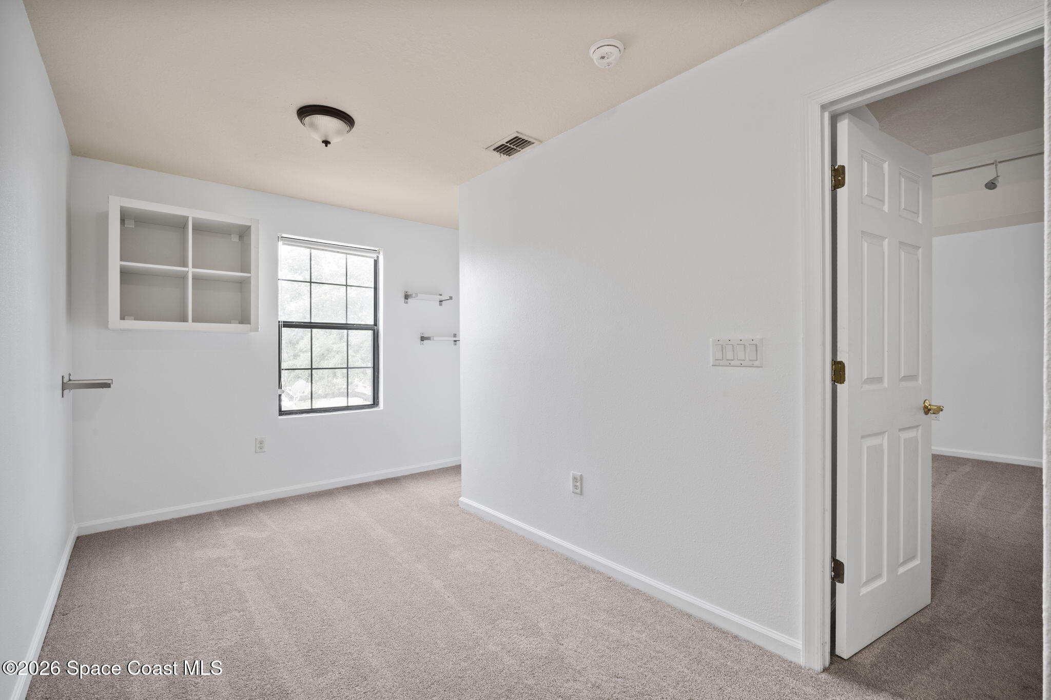 4555 Radiant Way, Unit 103 Melbourne, FL 32901 - Photo 28 of 58 an empty room with windows and closet