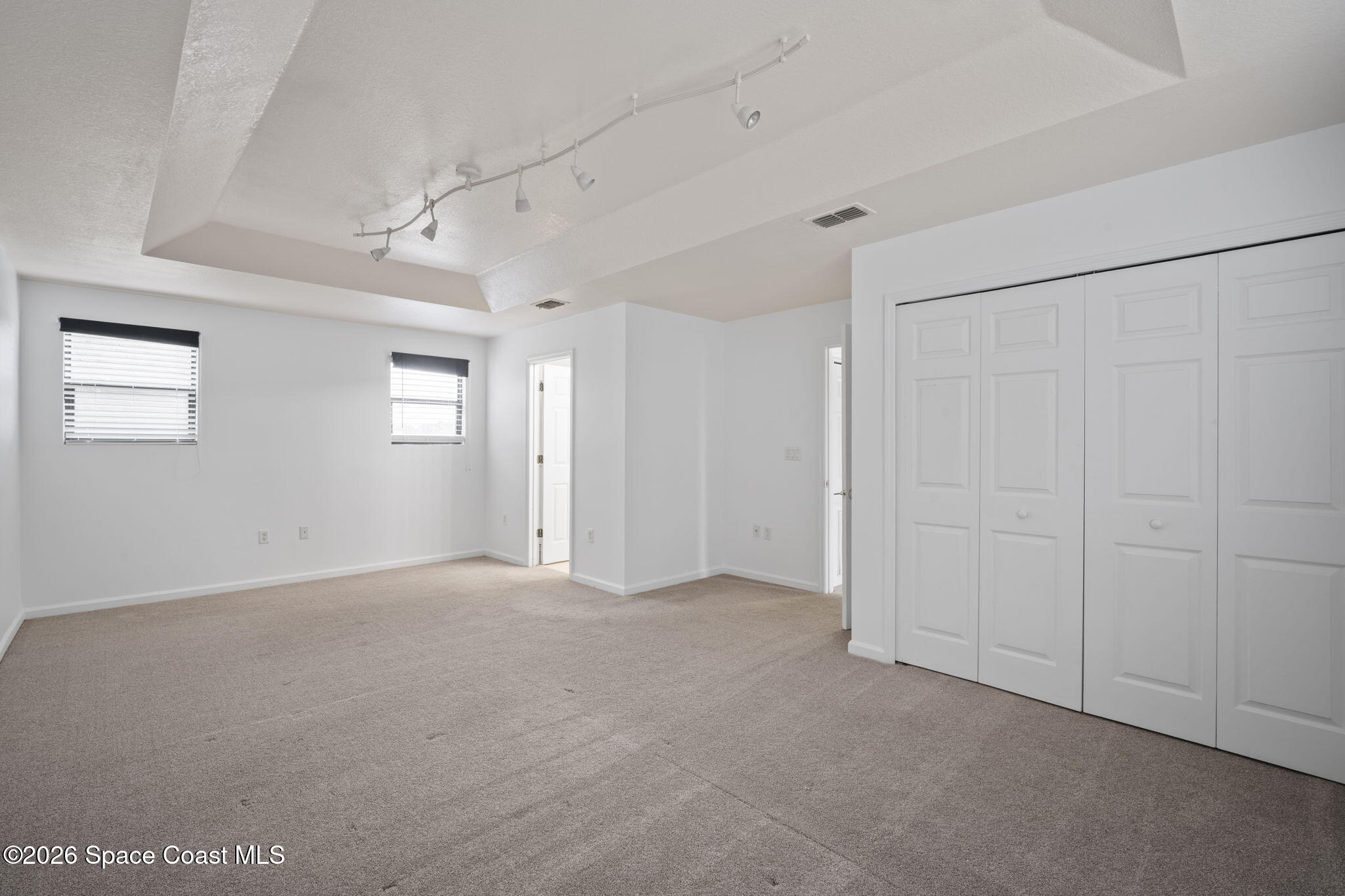 4555 Radiant Way, Unit 103 Melbourne, FL 32901 - Photo 31 of 58 a view of an empty room with windows