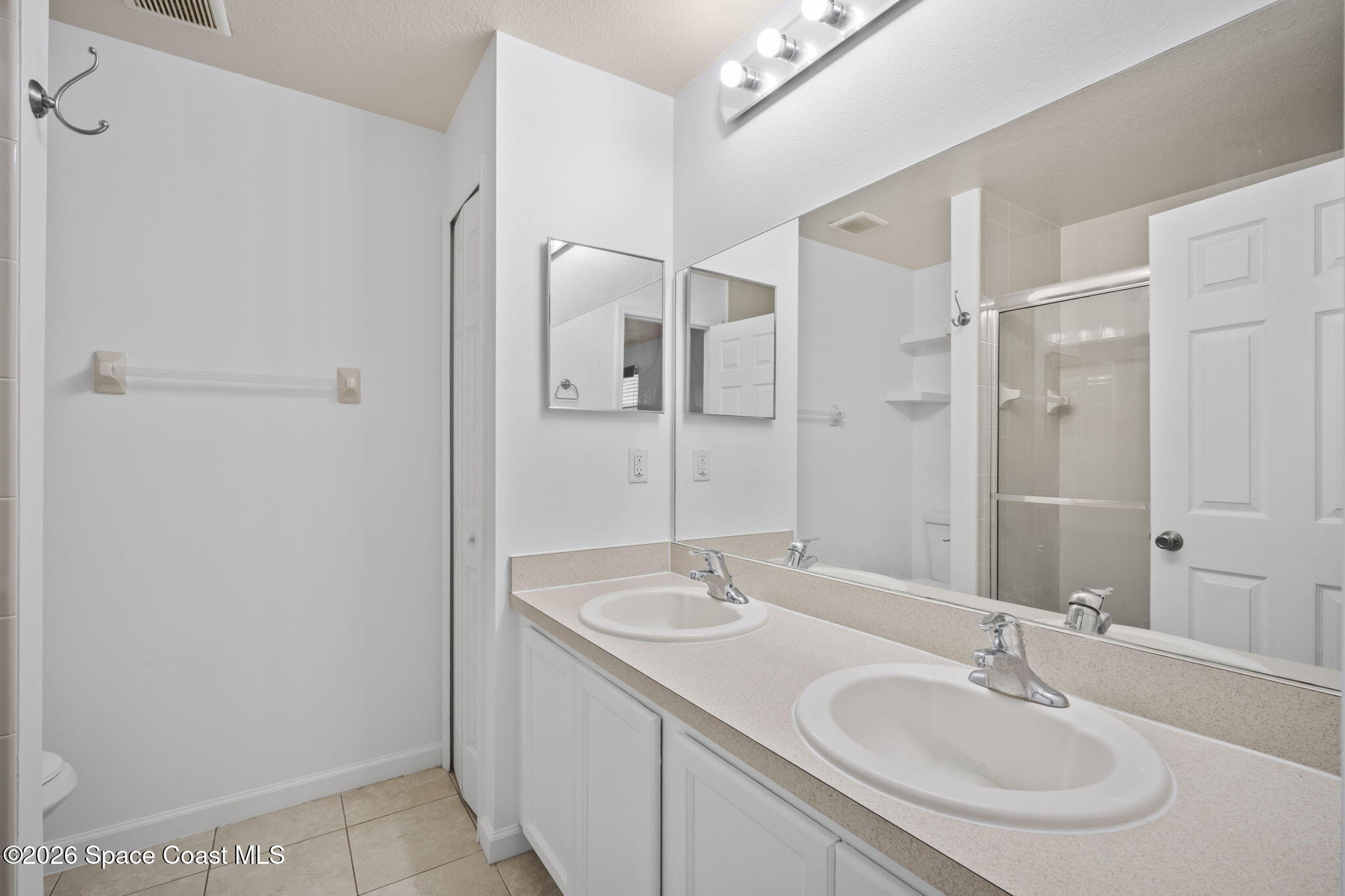 4555 Radiant Way, Unit 103 Melbourne, FL 32901 - Photo 35 of 58 a bathroom with a sink shower and a mirror