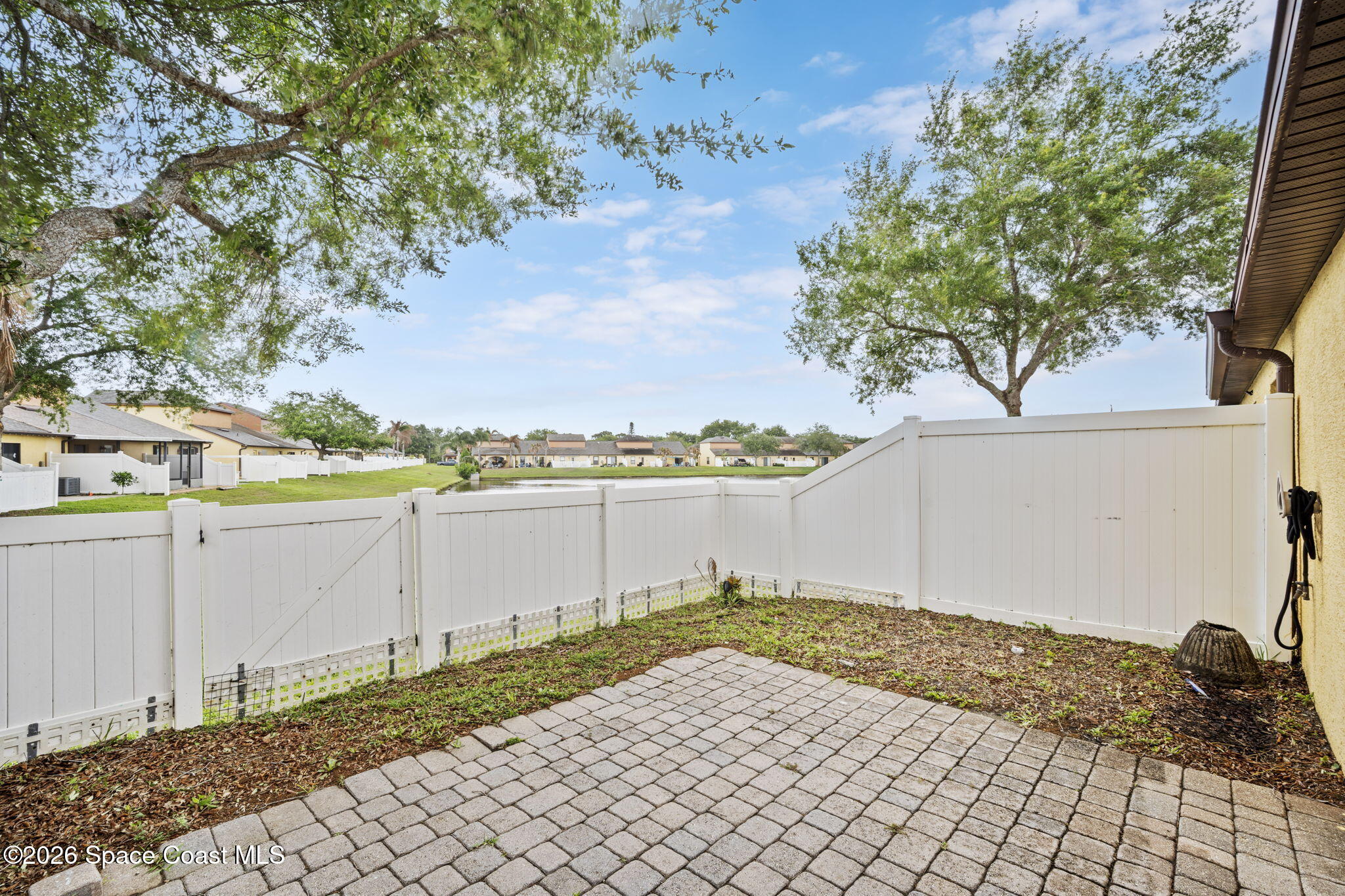 4555 Radiant Way, Unit 103 Melbourne, FL 32901 - Photo 37 of 58 a view of a backyard of the house