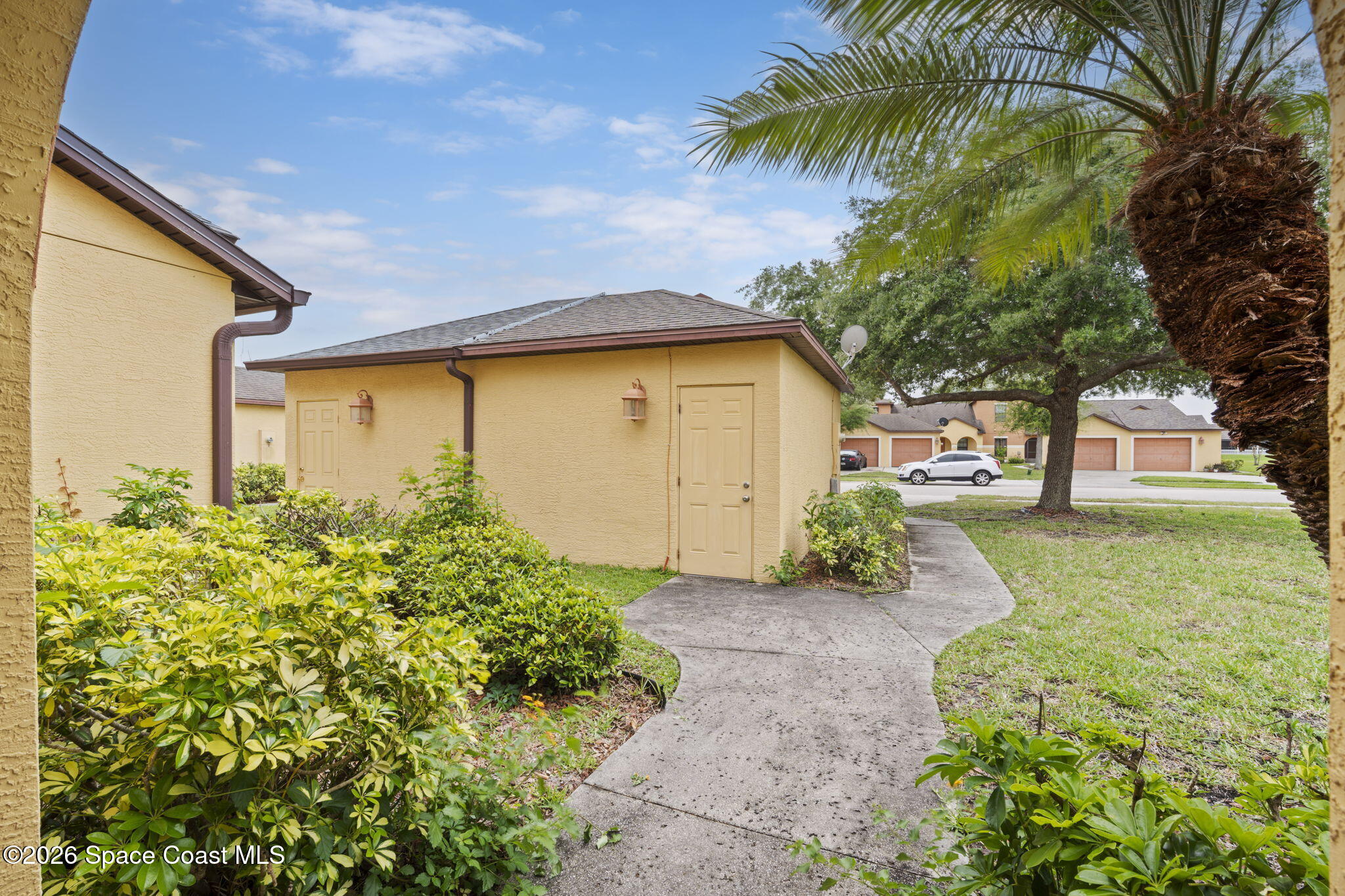 4555 Radiant Way, Unit 103 Melbourne, FL 32901 - Photo 39 of 58 a front view of a house with garden