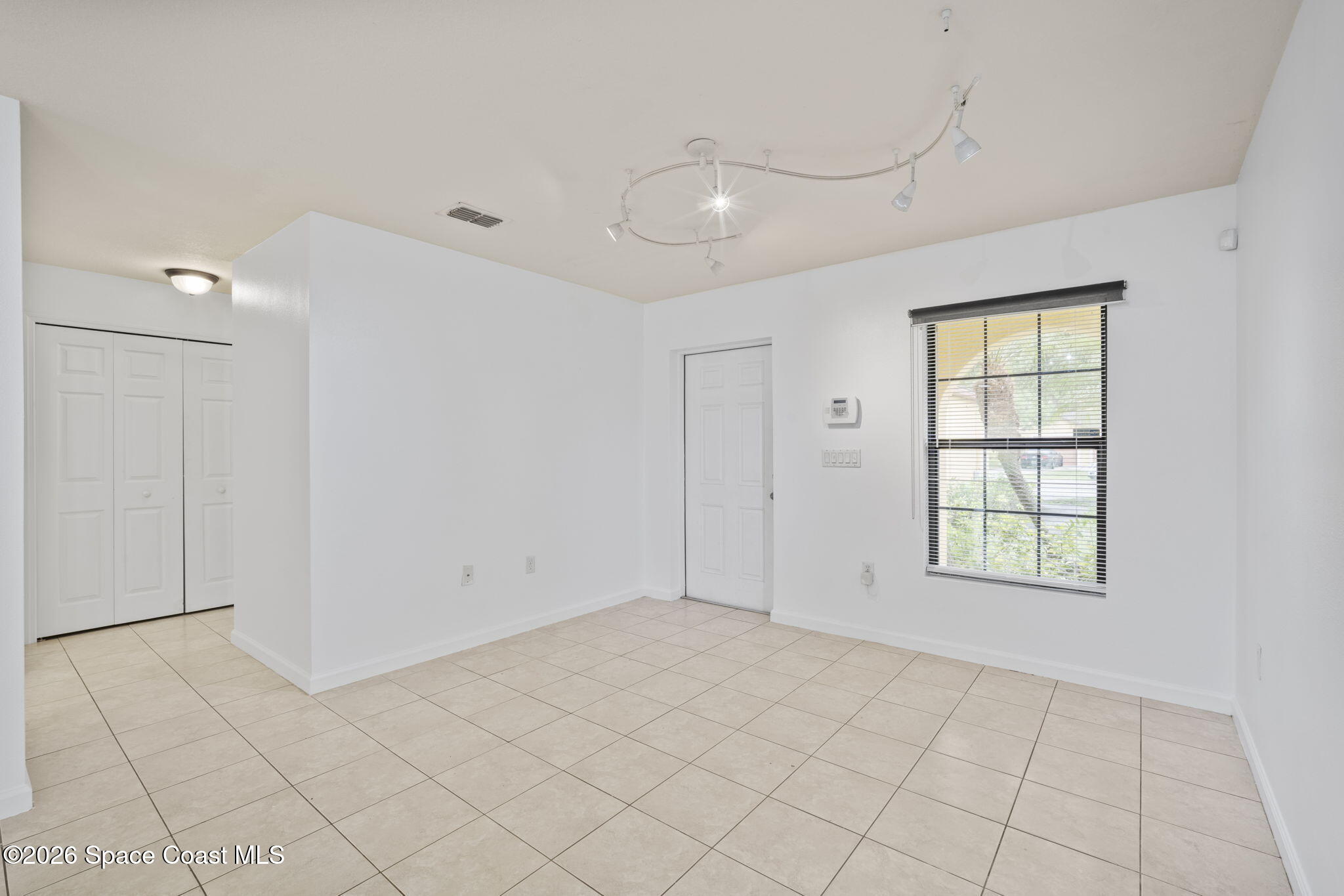4555 Radiant Way, Unit 103 Melbourne, FL 32901 - Photo 8 of 58 an empty room with windows and closet