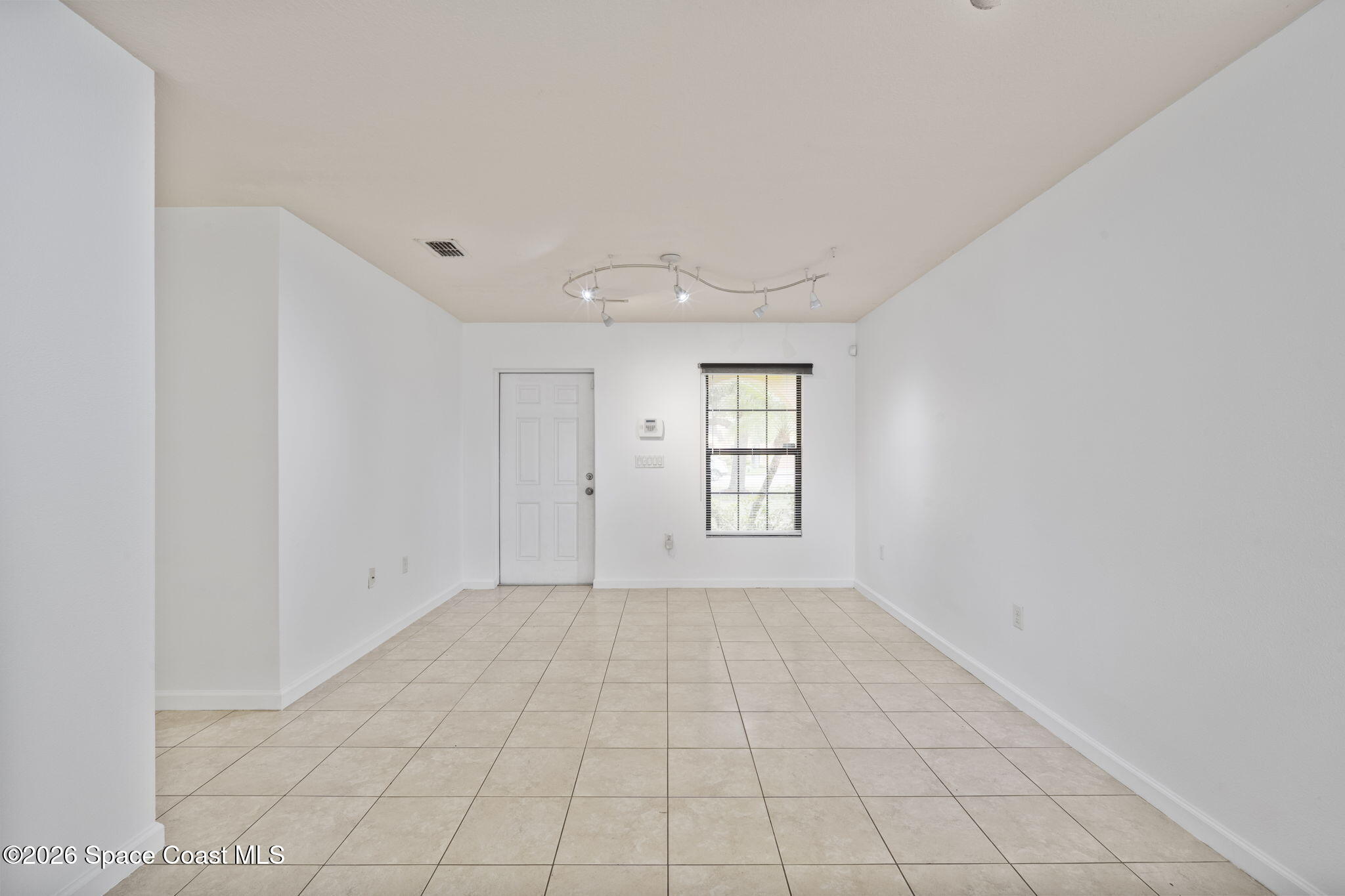 4555 Radiant Way, Unit 103 Melbourne, FL 32901 - Photo 9 of 58 a view of an empty room with a window