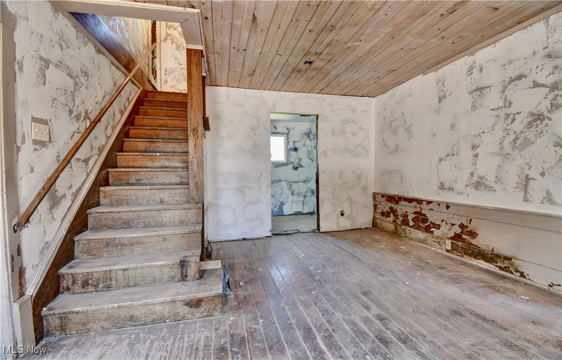 14875 Navarre Road Southwest Wilmot, OH 44689 - Photo 13 of 40 Staircase featuring wood ceiling and wood-type flooring