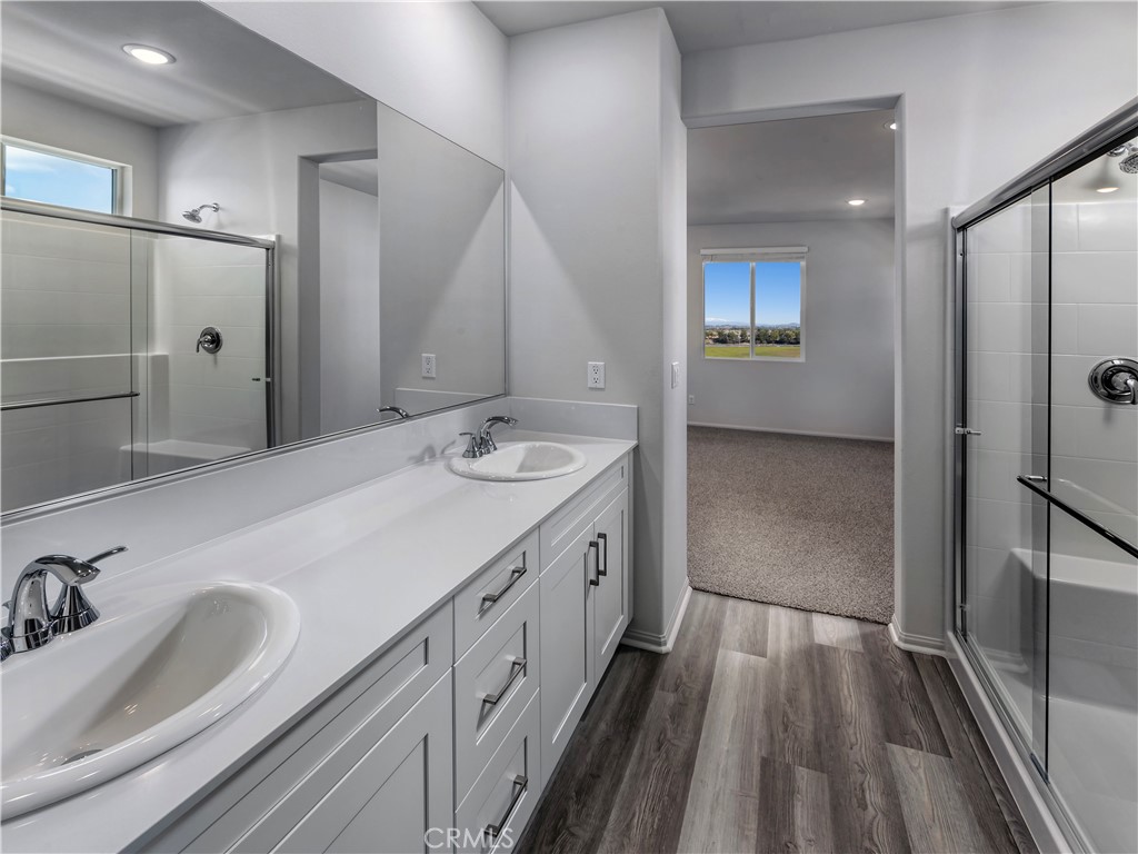 28500 Via Priorat Temecula, CA 92591 - Photo 5 of 7 a spacious bathroom with a double vanity sink a mirror and shower