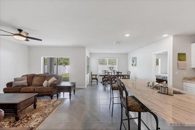 a living room with furniture a rug and a window