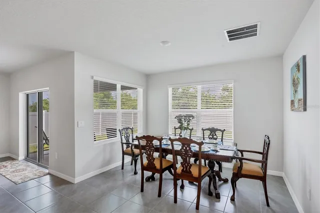 a view of a dining room with furniture and windows