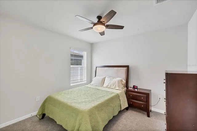 a bedroom with a bed and window