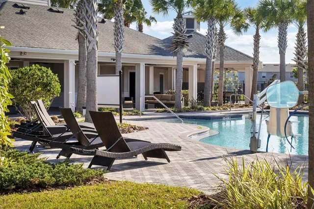 a view of a house with swimming pool and sitting area