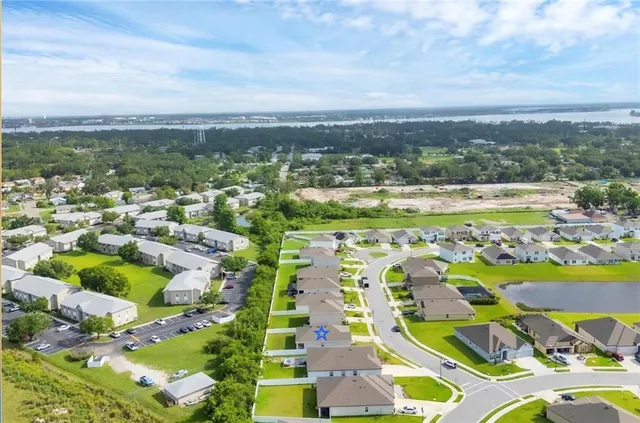 an aerial view of residential houses with outdoor space