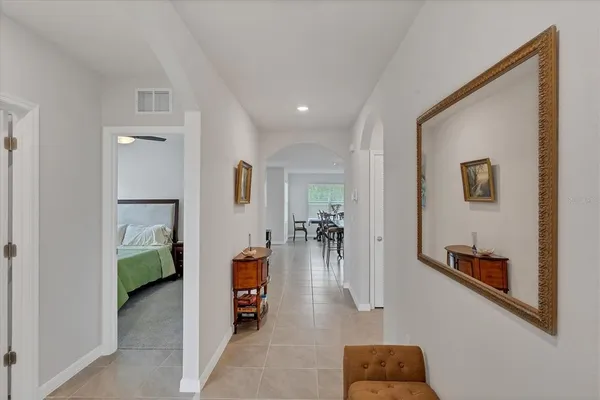 a hallway with a couch and chandelier