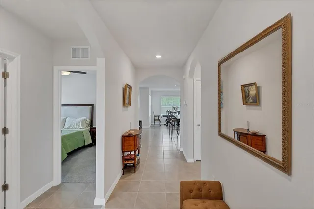 a hallway with a couch and chandelier