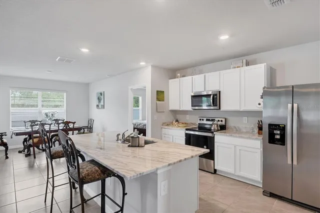 a kitchen with appliances cabinets and a counter top space