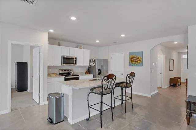 a kitchen with stainless steel appliances granite countertop a refrigerator and microwave