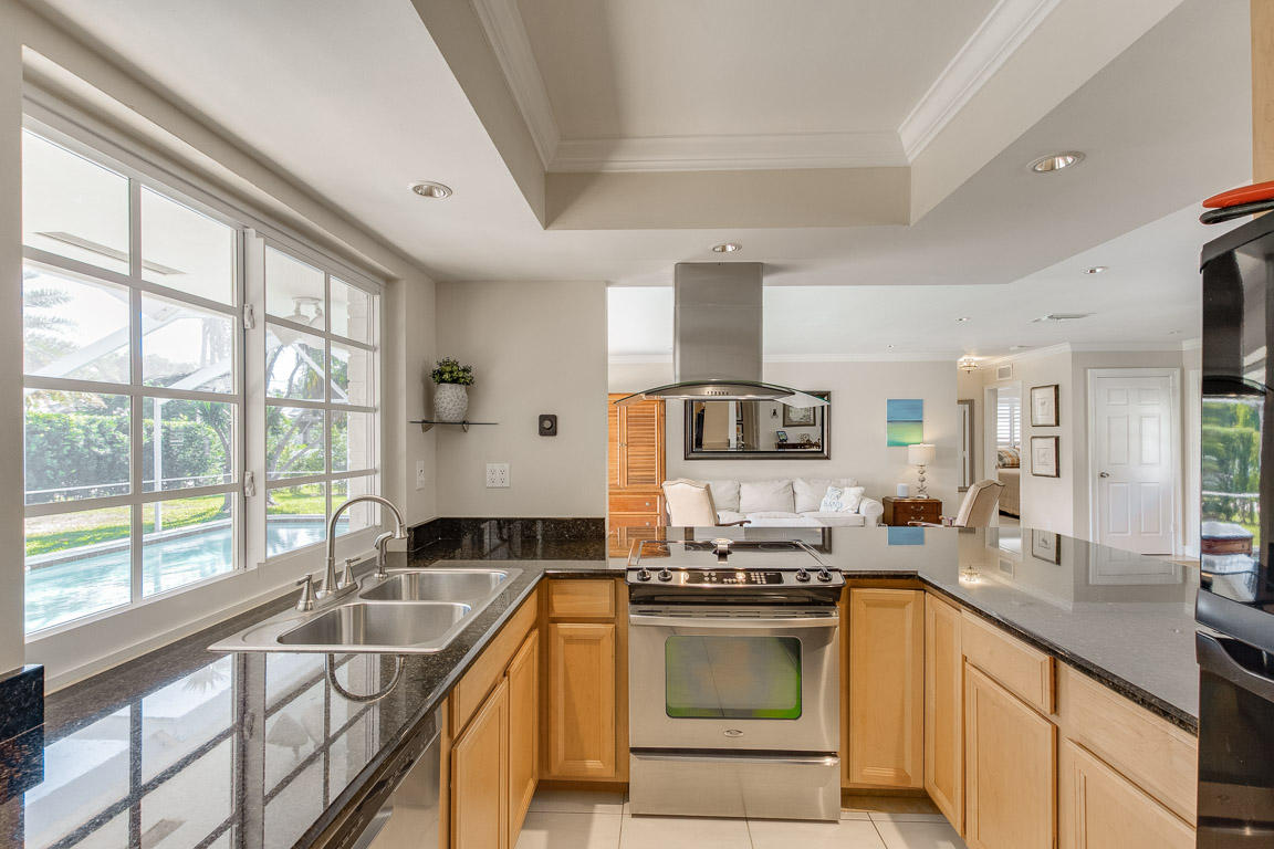 601 Southwest 1st Street Boca Raton, FL 33486 - Photo 8 of 32 a kitchen with stainless steel appliances granite countertop a sink stove and cabinets