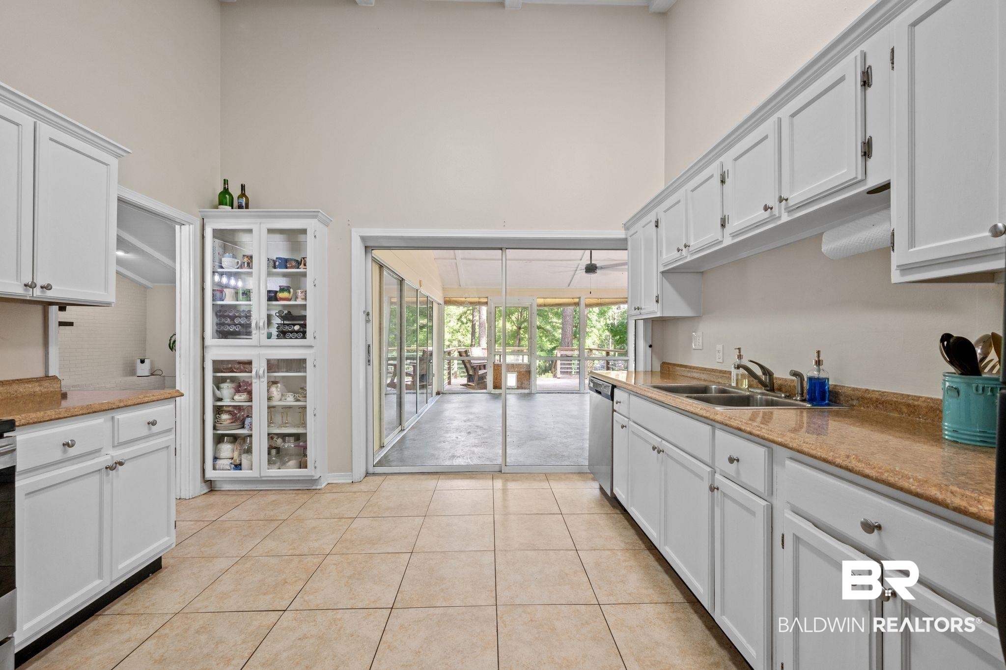 110 Ferncliff Circle Daphne, AL 36526 - Photo 16 of 40 Kitchen with a towering ceiling, dishwasher, a sink, light tile patterned flooring, and white cabinets