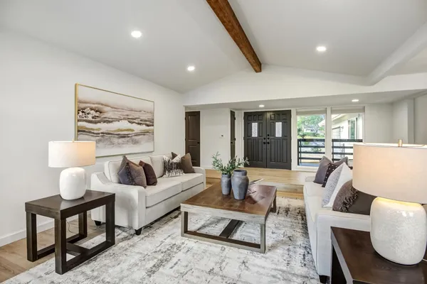 a living room with furniture and wooden floor