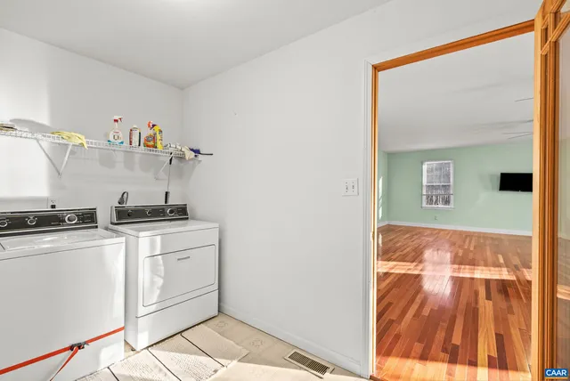 a living room with furniture and wall painting