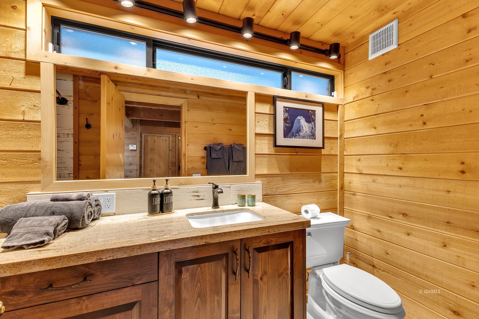 24924 Fern Valley Road Idyllwild, CA 92549 - Photo 68 of 72 a bathroom with a granite countertop toilet sink and mirror